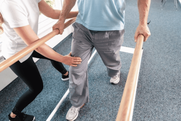 Patient holding a balance bar during neurophysical therapy at CNS Brain Center in Chicago for post-concussion rehabilitation