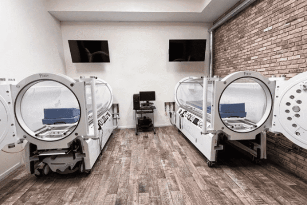 Large white hyperbaric oxygen chamber in a treatment room at CNS Brain Center in Chicago