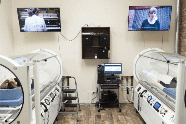 Clear acrylic medical-grade HBOT chamber in a treatment room at CNS Brain Center Chicago